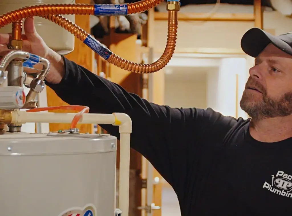Person working on plumbing installation.